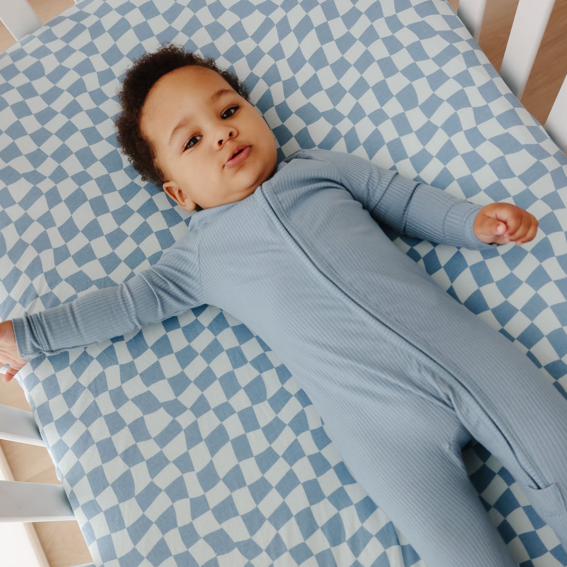 Copper Pearl Premium Knit Fitted Crib Sheet in soft knit fabric with elastic edges, designed for a secure fit on a crib mattress.