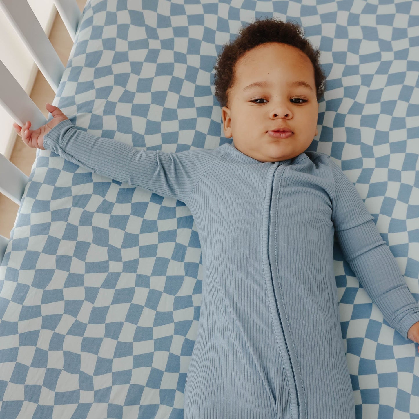 Copper Pearl Premium Knit Fitted Crib Sheet in Miles pattern, showing soft, snug-fitting fabric for a baby's crib.