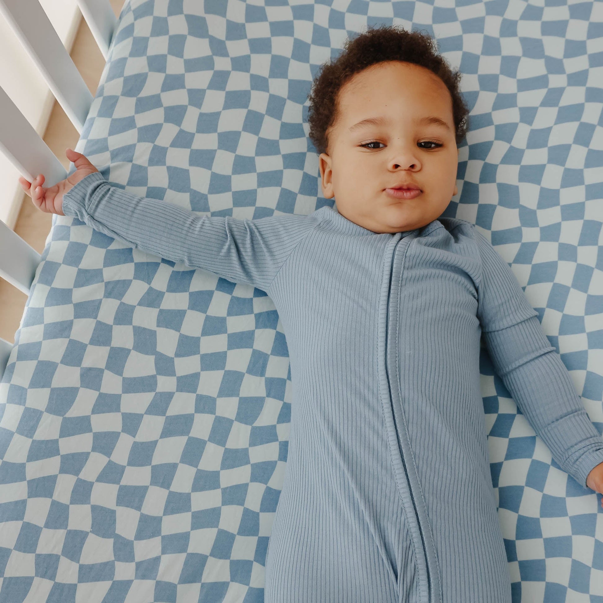 Copper Pearl Premium Knit Fitted Crib Sheet in Miles pattern, showing soft, snug-fitting fabric for a baby's crib.