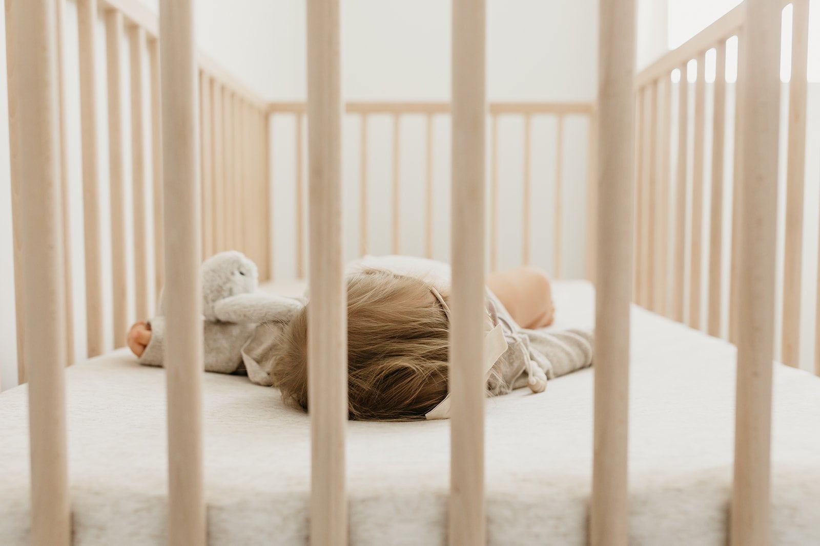 Copper Pearl premium knit fitted crib sheet in oat color, soft and snug for a cozy baby crib.