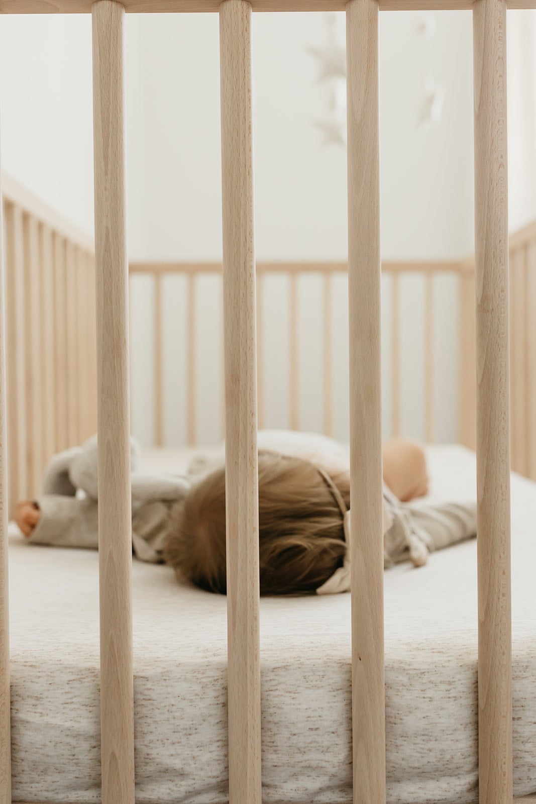 Copper Pearl premium knit fitted crib sheet in oat color, soft and snug for a cozy baby crib.
