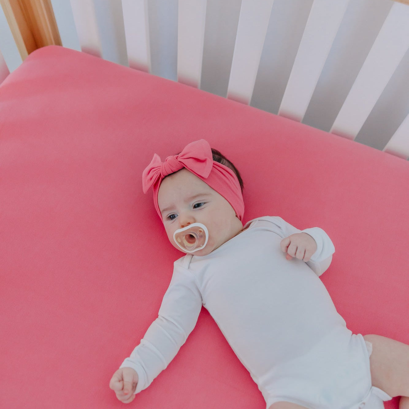 Copper Pearl Premium Knit Fitted Crib Sheet in flamingo color, featuring soft, stretchy fabric and snug fit for baby's crib.