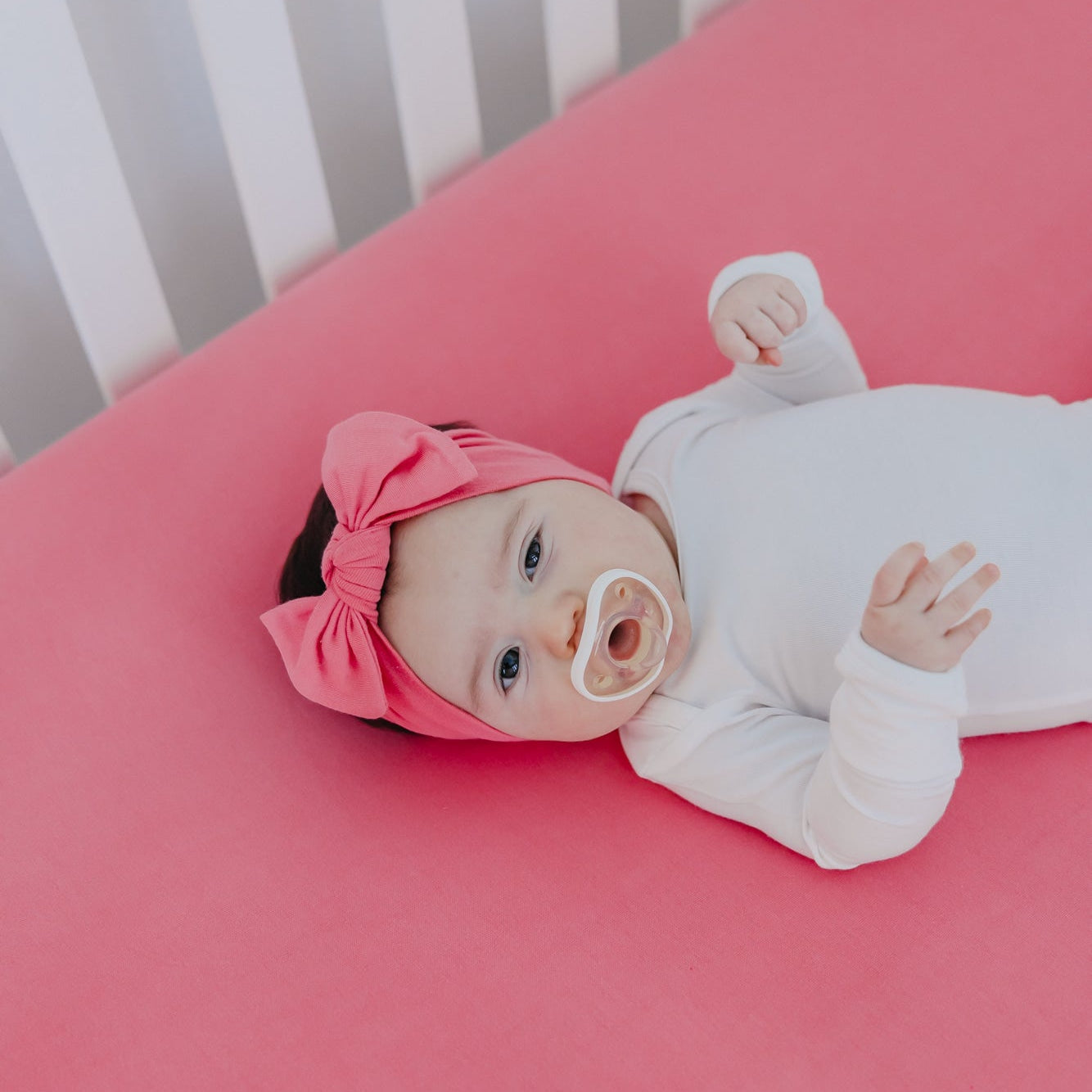 Copper Pearl premium knit fitted crib sheet with flamingo print, soft and snug-fitting for baby cribs.