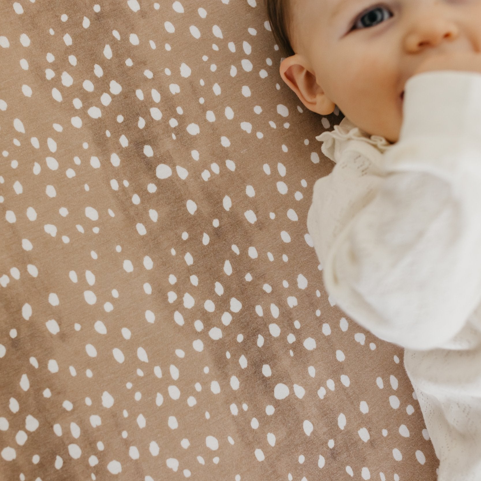 Copper Pearl premium knit fitted crib sheet in fawn color, featuring soft, snug fit and cozy fabric for baby cribs.