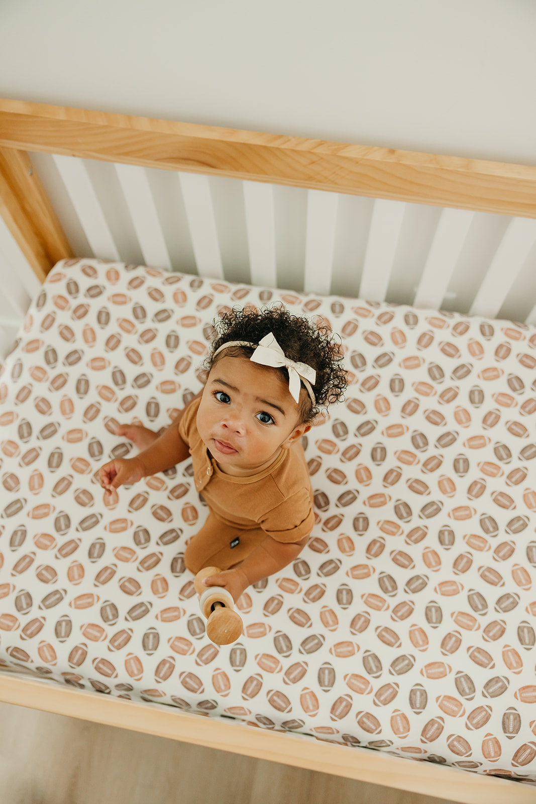 Copper Pearl premium knit fitted crib sheet in a soft, cozy fabric with a subtle pattern, designed for a secure fit on a crib mattress.