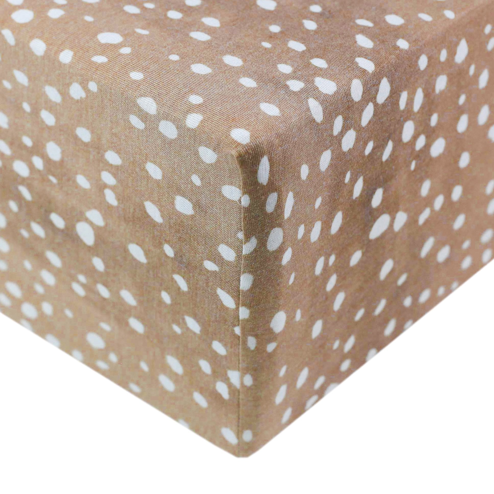 Copper Pearl knit fitted crib sheet in Fawn color, featuring soft, cozy fabric and snug fit for a baby's crib.